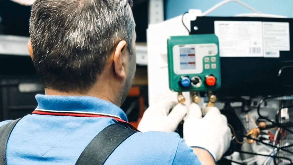 Technician checking AC pressure gauges, ad schedule for HVAC Google Ads
